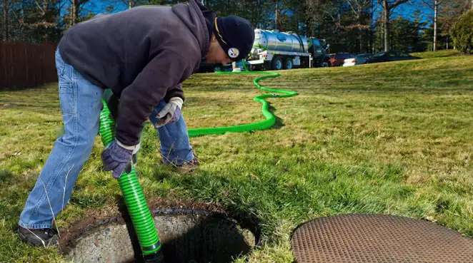 Service technician performing residential septic pumping and drainage maintenance in Cleveland, OH